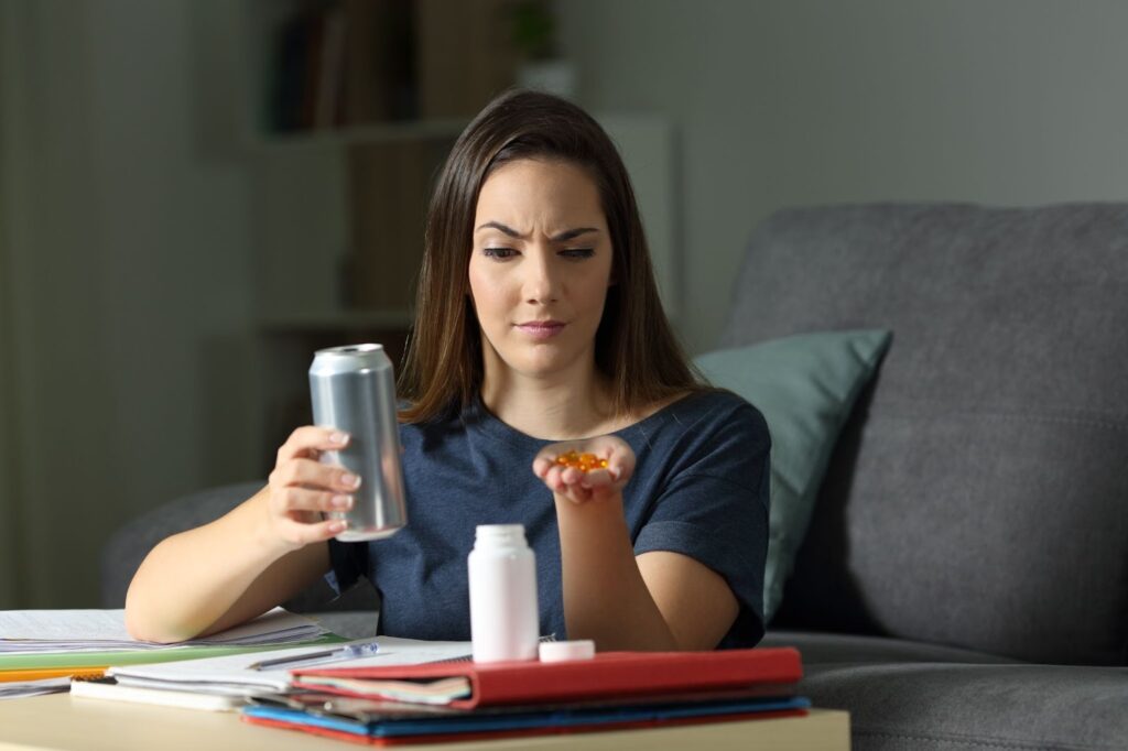 woman questioning the vitamins and supplements she is holding